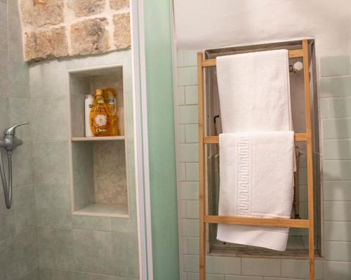 a towel rack in a bathroom with towels at Trulli Garden in Alberobello