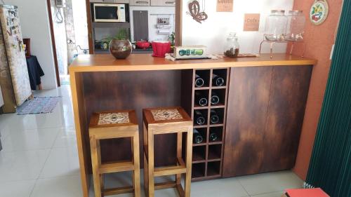 a kitchen with a counter with a bunch of wine bottles at Sítio Sapiranga in Sapiranga