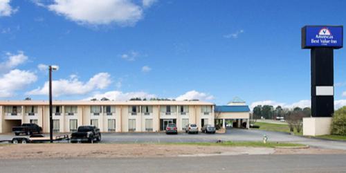 a large building with cars parked in a parking lot at Americas Best Value Inn Marshall in Bel Air
