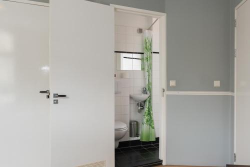 a bathroom with a toilet and a sink at Westerpark Home in Amsterdam