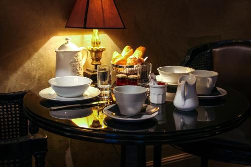 a table with cups and plates of food on it at Villa Glamour in Paris