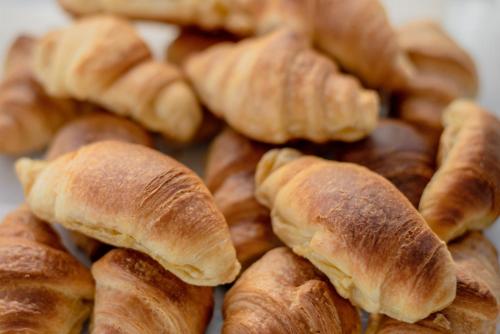 a pile of croissants are sitting on a plate at Sunday Hotel in Ialyssos