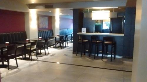 a restaurant with tables and chairs and a bar at ARC Recoleta Boutique Hotel & Spa in Buenos Aires