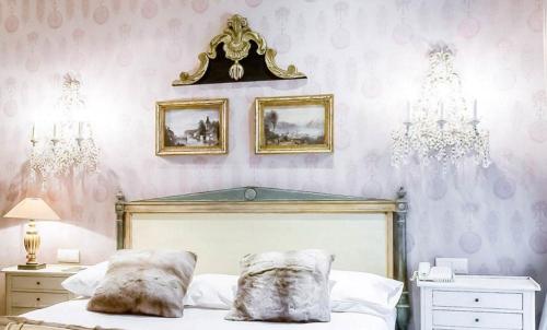 a bedroom with a bed with two pillows on it at Hôtel du Romancier in Paris
