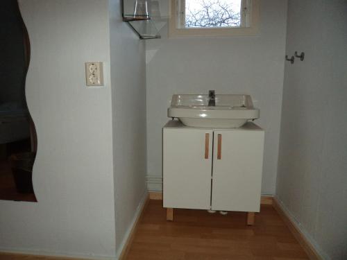 a white bathroom with a sink and a mirror at Gamla Bryggeriet Bed & Breakfast in Köpingsvik