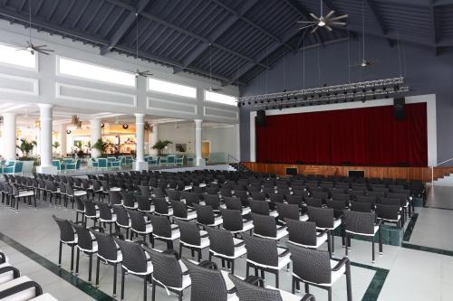an empty hall with a stage and chairs at Bahia Principe Fantasia Punta Cana - All Inclusive in Punta Cana