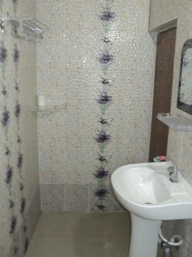 a bathroom with a toilet and a sink at Royal Paying Guest in Kolkata