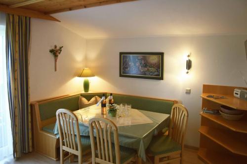 a dining room with a table with chairs and a table and a table and chairs at Ferienhaus Steger Maria in Flachau