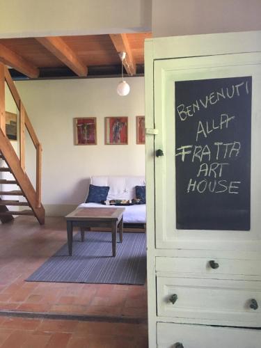 a room with a bedroom with a bed and a dresser at La Fratta Art - House in Marsciano