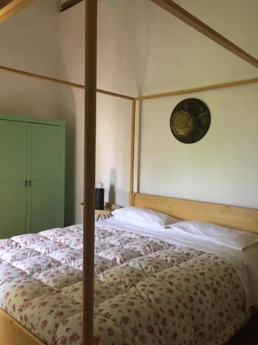 a bedroom with a bed with a wooden canopy at La Fratta Art - House in Marsciano