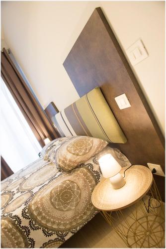 a bedroom with a bed with a lamp and pillows at Dolce Vita in Zafferana Etnea