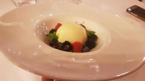 a dessert in a white bowl on a table at Hotel Europeo Alpine Charme & Wellness in Pinzolo