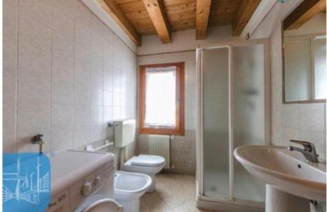 a bathroom with a toilet and a sink and a mirror at CasaMarin2 in Caorle