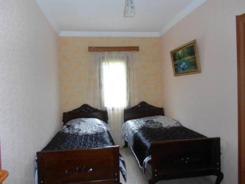 two beds in a room with a window at Мзетамзе 59 in Borjomi