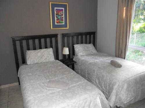 two beds sitting next to each other in a bedroom at Kingfisher D in Shelly Beach