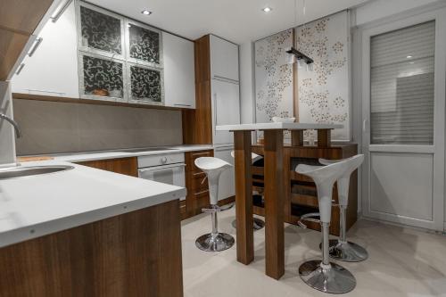a kitchen with a counter and stools in it at Central Park Apartments in Belgrade