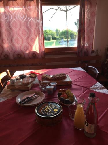 a table with plates of food on a red table cloth at La Fontanella in Montecchia di Crosara