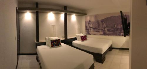 Ένα ή περισσότερα κρεβάτια σε δωμάτιο στο Hotel Maya Rue