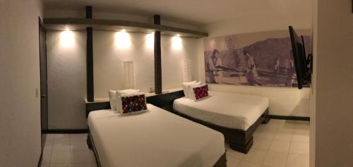 Postel nebo postele na pokoji v ubytování Hotel Maya Rue