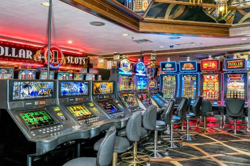 a casino with lots of slot machines and chairs at Winnemucca Inn & Casino in Winnemucca