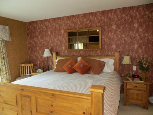 a bedroom with a large bed with brown pillows at Buffaloberry Bed & Breakfast in Banff
