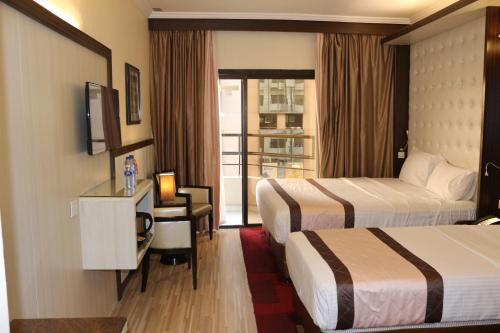 Postel nebo postele na pokoji v ubytování Al Khaleej Grand Hotel
