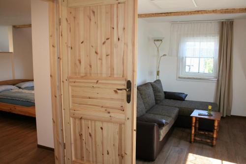 a door leading into a living room with a couch at Zum-Seiffener-Sprengmeister in Kurort Seiffen