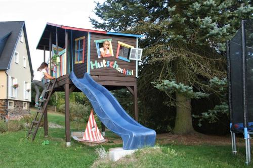 a play house with a slide and a child on it at Zum-Seiffener-Sprengmeister in Kurort Seiffen