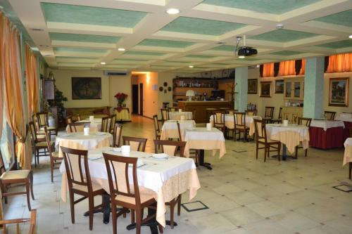 a restaurant with tables and chairs in a room at Albergo La Piana in Ghedi