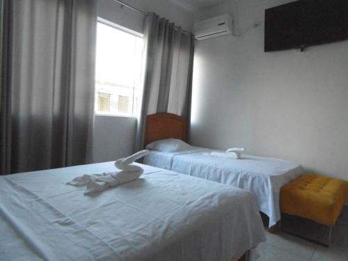 Postel nebo postele na pokoji v ubytování Hotel Tumpis