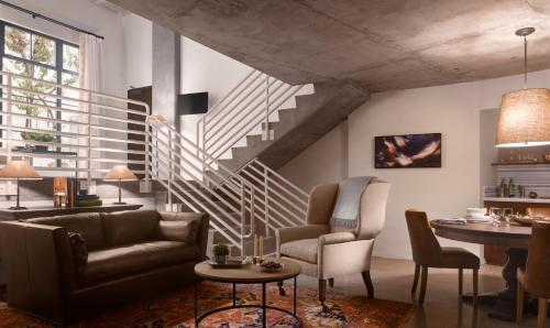 a living room with a couch and a staircase at Plaza la Reina in Los Angeles