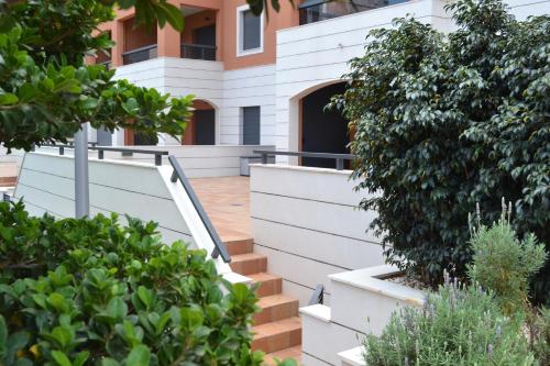 un edificio con escaleras y plantas delante de él en Jardines de Las Marinas - Royal Suite, en Denia