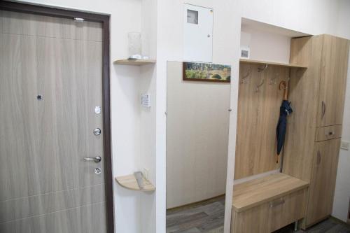 a bathroom with a shower and a door in a room at Odessa Heart in Odesa