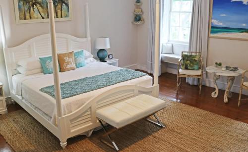 a bed room with a bed and a desk at Sweetfield Manor in Bridgetown