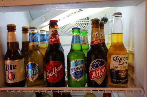 a refrigerator filled with lots of bottles of beer at Hotel Valle Verde in Valle de Anton
