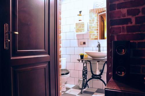 a bathroom with a sink and a toilet in a room at Familuks - Apartementy Katowice Ligota in Katowice