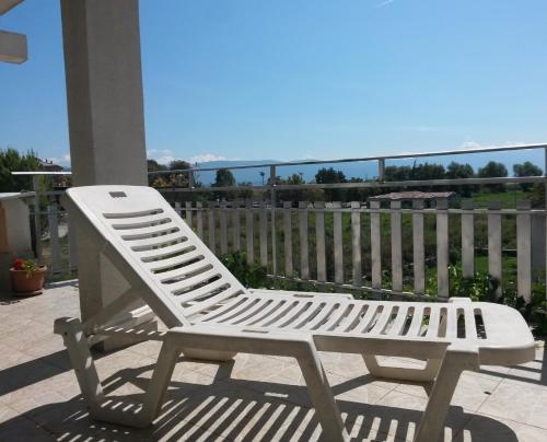 a white bench sitting on top of a patio at Marko Apartments in Struga