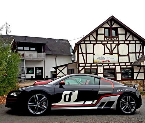a black and white car parked in front of a building at DF am Ring Nürburg in Nürburg