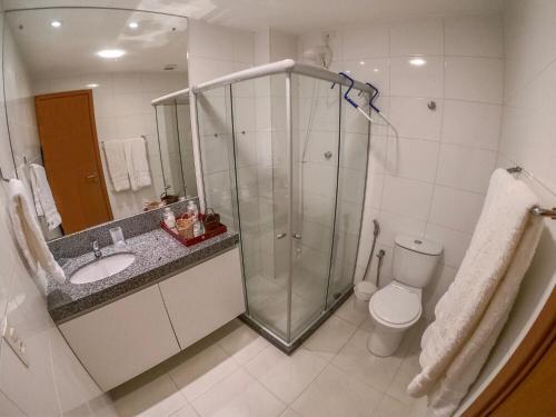 a bathroom with a shower and a sink and a toilet at Carneiros Beach Particular Flat in Praia dos Carneiros