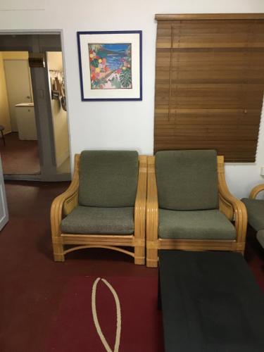 a room with two chairs and a table at Ocean View Apartments in Flying Fish Cove