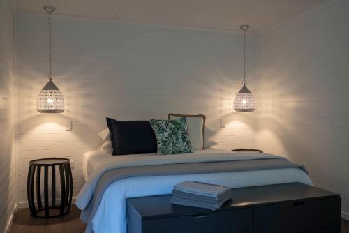 a bedroom with two pendant lights and a bed at mist at Cape Tribulation in Cape Tribulation