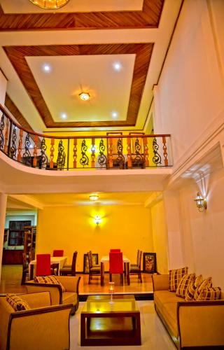 a living room with couches and a balcony at Siluni's Villa in Anuradhapura