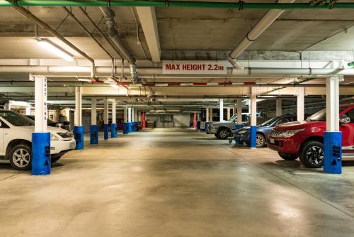 a parking garage with cars parked in it at Edgewater Palms Apartments in Paihia
