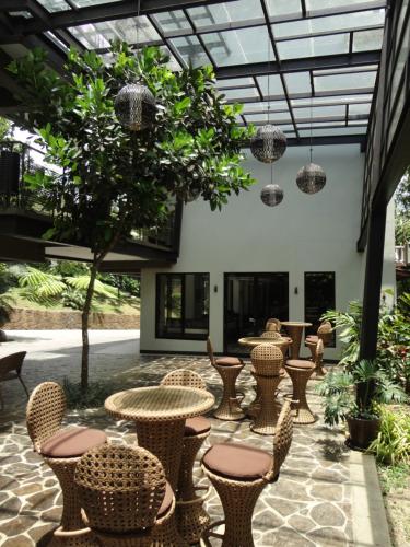 a patio with tables and chairs in a building at Abagatan ti Manila in Alfonso