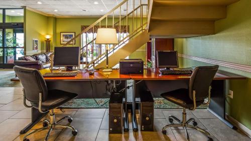 an office with two computers on a desk with chairs at Best Western Shepherdsville in Shepherdsville