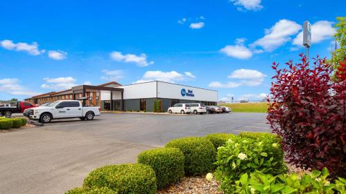 a dealership with cars parked in a parking lot at Best Western Shepherdsville in Shepherdsville