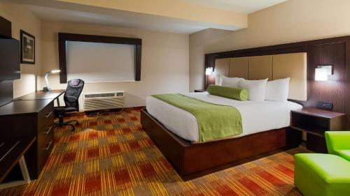 a hotel room with a large bed and a desk at The Inn on Storrs in Mansfield Center