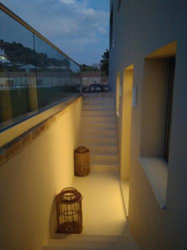 a stairway with two baskets and a hallway with stairs at Belvedere Luxury Apartments & Spa in Plakias