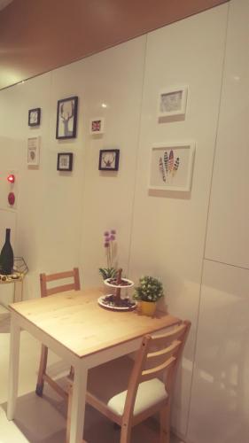 a wooden table with two chairs and a table with plants on it at Ze Hu B&B in Yuchi