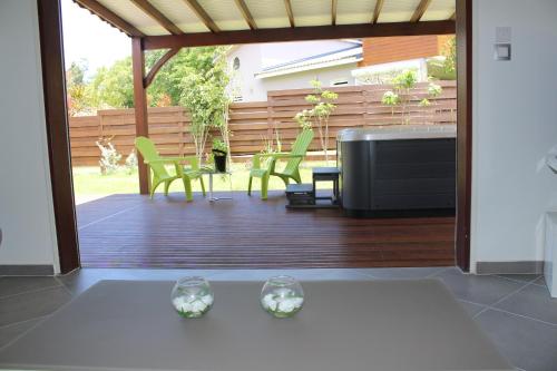 a patio with two wine glasses on a table at La COOL & DOUCE - Villa COOL in Le Gosier